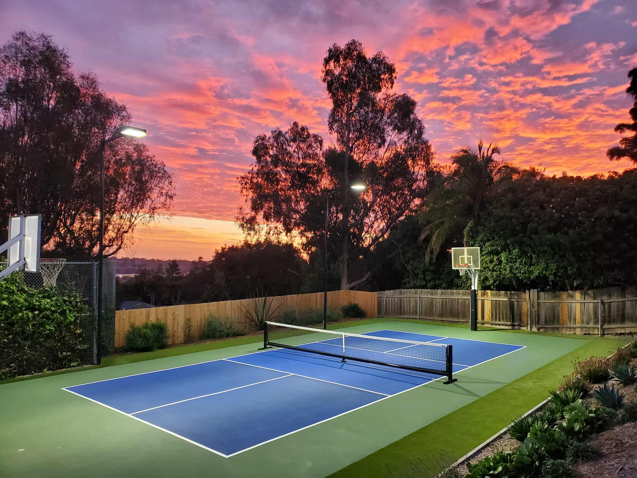 Backyard pickleball court at sunset